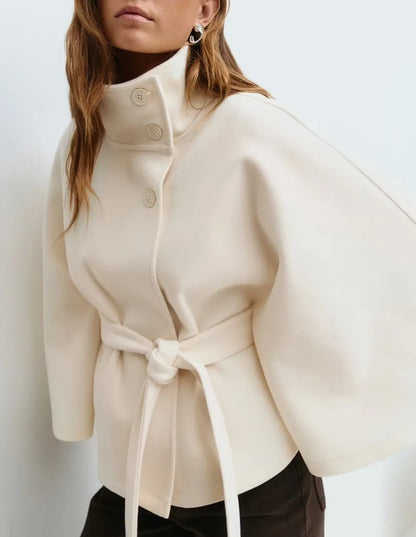 https://cdn.shopify.com/s/files/1/0957/7286/8982/files/Womens-Short-Cape-Coat-Funnel-Neck-Belted-Waist-Cape-Sleeves-4.webp?v=1770237641